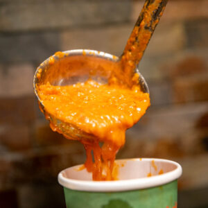 Soup being poured into a cup