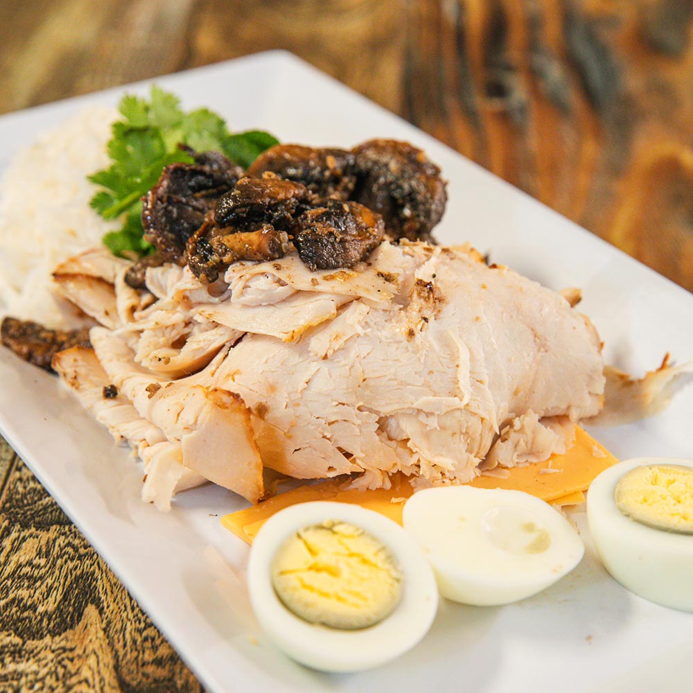 Sliced turkey with eggs, mushrooms, and cheese